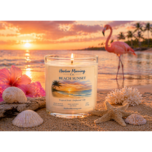 Harbor Morning Co. Beach Sunset 8oz hand-poured coastal soy candle in a beach setting with flamingo in the background