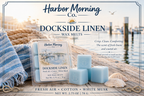 Harbor Morning Co. Dockside Linen coastal wax melts on a weathered pier with nautical beach towel, shipping rope, wax cubes, boats, seagull, and calm waters — a true coastal moment