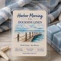 Harbor Morning Co. Dockside Linen sea blue coastal wax melts on a weathered wooden table with seashells and starfish