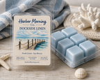 Harbor Morning Co. Dockside Linen sea blue coastal wax melts on a weathered wooden table with seashells and starfish