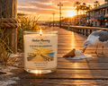 Harbor Morning Co. Golden Boardwalk 8oz hand-poured coastal soy candle with a Gulf Coast boardwalk sunset scene — seagull, palm trees, and beachside businesses in the background