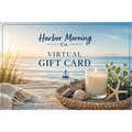 Harbor Morning Co. coastal gift card featuring a lit candle in a wicker basket with sea oats, shells, and starfish on a white sandy beach at sunrise — gift the feeling of coastal wellness