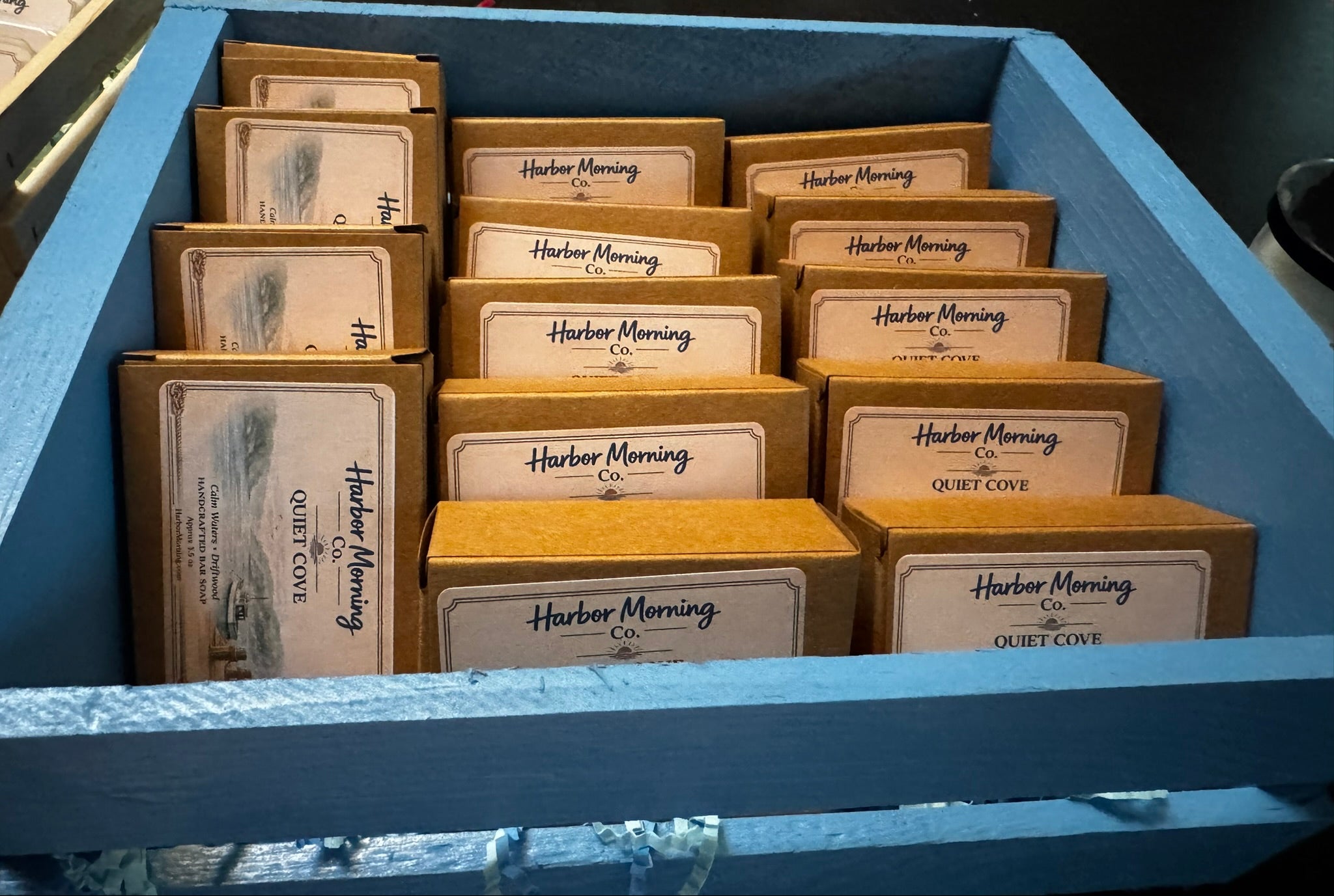 Harbor Morning Co. Quiet Cove handcrafted goat milk soap label featuring calm cove waters, driftwood, and a small fishing boat tied to a pier