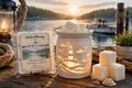 Harbor Morning Co. Quiet Cove 3.5oz coastal wax melts on a dock with lit wax warmer, weathered rope, seashell, nautical lamp, and a quiet cove fishing boat in the background